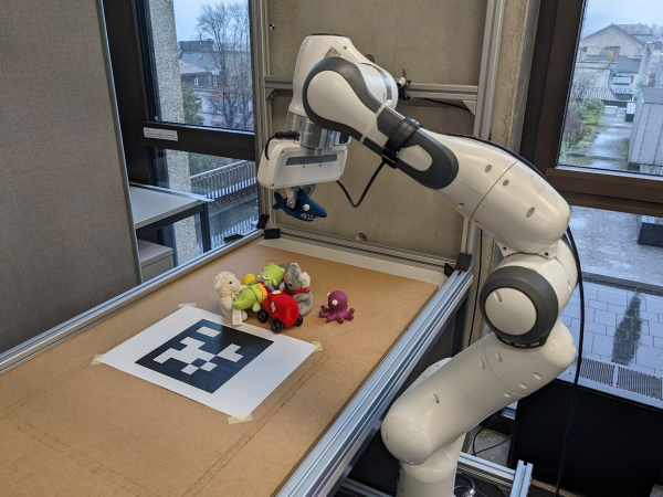 Enlarged view: a robot arm reaching for stuffed animals